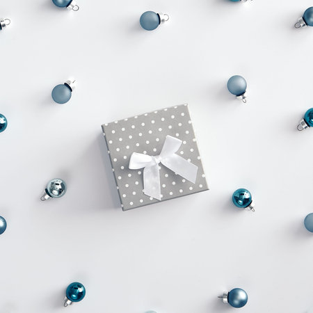 Christmas minimal concept - blue christmas baubles on white background. Gray gift box. Mockup with...