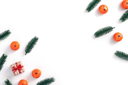 Christmas minimal concept - Christmas composition made of tree branch, gift box and tangerine on white background. Isolated white background. Christmas pattern top white for celebration design.の写真素材