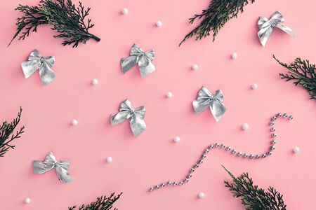 Christmas minimal concept - composition with christmas bow, tree branch and snowball on pink background. White paper frame. Winter xmas snow background. Minimal holiday concept. Holiday mockup.の写真素材