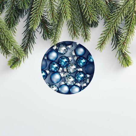 Christmas minimal concept - creative abstract christmas bauble made of xmas balls and tree branch. Minimal holiday concept. Creative minimal. Minimal flatlay. Christmas holiday template.の写真素材