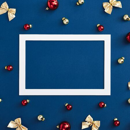 Red ball, golden bow and snowflake on classic blue background. Trendy classic blue color 2020の写真素材