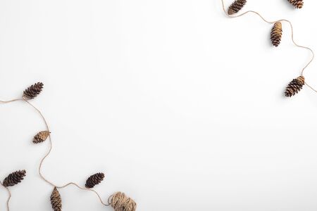 Zero waste christmas garland made from pine cone and natural jute twineの写真素材