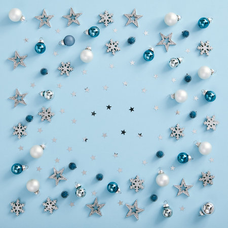 Christmas minimal mockup - white, silver and blue balls, snowflakes and stars confetti on blue...