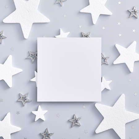 Christmas minimal mockup - red xmas ball, bow and gold snowflake on white background. Square composition with xmas corner decoration. Flat lay, top view. Red, gold and white templateの写真素材