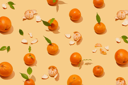 Orange pattern on colorful background. Creative seamless background with orange peel and green leaf. Summer healthy food conceptの写真素材