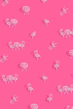 White metal chair and table on bright pink background. Creative trendy layout with sunshine and hard shadow. Cafe, restaurant, summer minimal concept.の写真素材