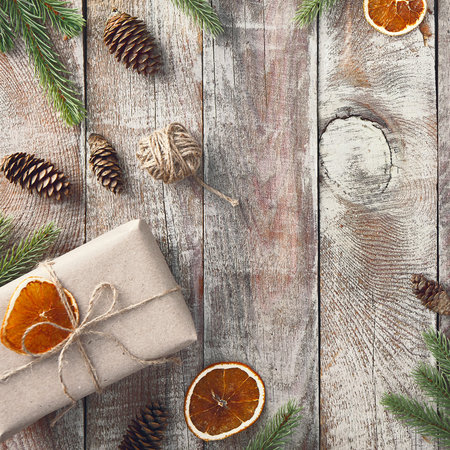 Square top view with a wooden background, highlighting festive elements on the left and an ample...