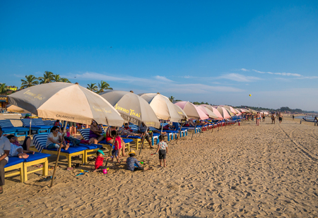 Goa, India - December, 21 2017 : Unidentified tourist relaxing using Beach beds and umbrellas to relax at North Goa beach called Baga Beachのeditorial素材