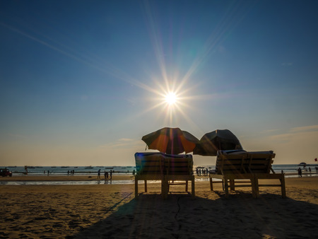 Goa, India - December, 21 2017 : Beach bed with umbrella with sun flares at North Goa beach called Baga Beachのeditorial素材