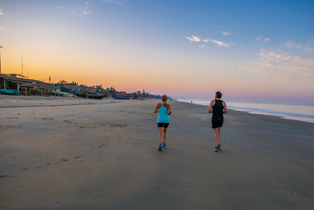 Goa, India - December, 22 2017 :Enjoying sports lifestyle. Healthy couple running on the sea shore.のeditorial素材