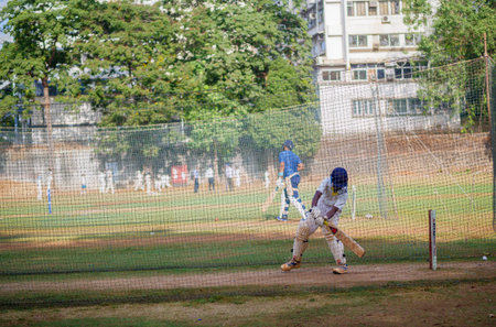 Mumbai, India - April 21, 2018: Unidentified boy practicing batting to improve cricketing skills at...