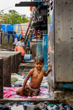 MUMBAI, INDIA - JULY 7, 2016 : Child of India - portrait of India young small girl child ready to take a bathのeditorial素材