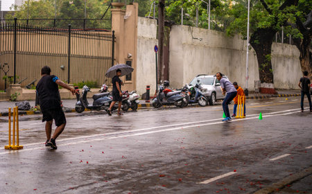 Mumbai, India - June 24, 2018 : Boys playing cricket on streets at Ballard Estate, South Mumbai