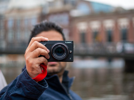 Amsterdam, Netherlands - August 26, 2018: Unidentified Tourist clicking photo using Panasonic Lumix...