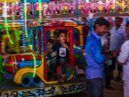 Mumbai, India - December 01, 2019: Indian kid enjoying carousel ride in a Train engine at amusement parkのeditorial素材