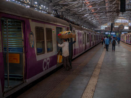 Mumbai, India - December 14, 2019: Commuters walking inside Laguauge compartment inside Chhatrapati Shivaji Terminus Railway Station, a historic railway station and a UNESCO World Heritage Site in Mumbai, Maharashtra, Indiaのeditorial素材