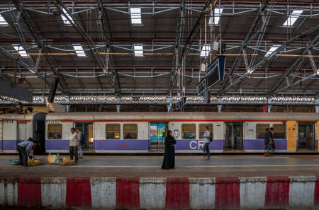 Mumbai, India - December 18, 2019 : Unidentified Muslim woman standing on a platform at CST station, one of the bussiest train station for working class people in Mumbaiのeditorial素材