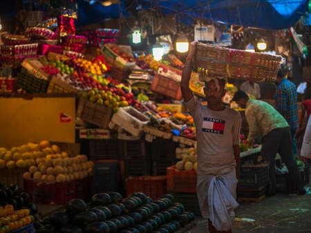 Mumbai, India - December 18, 2019 : A porter carrying empty cart in fruit market in South Mumbaiのeditorial素材