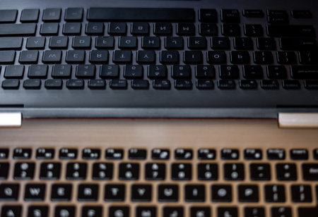 Closeup of laptop keyboard. Reflection of keys in laptop screen.