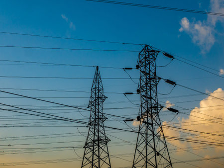 High-voltage power lines at Sunrise/sunset. electricity distribution station.