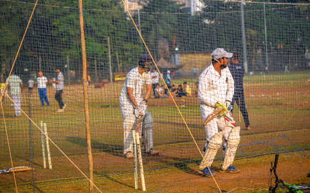 Mumbai, India - December 20, 2020: Unidentified boys practicing batting to improve cricketing skills at Mumbai groundのeditorial素材