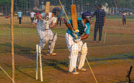 Mumbai, India - December 20, 2020: Unidentified boys practicing batting to improve cricketing skills at Mumbai groundのeditorial素材
