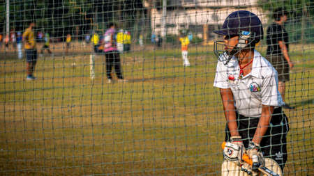 Mumbai, India - December 20, 2020: Unidentified boy practicing batting to improve cricketing skills at Mumbai groundのeditorial素材