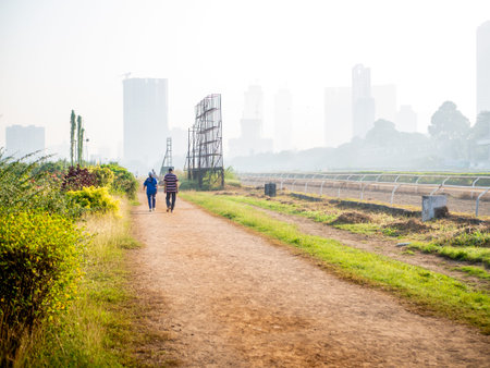 MUMBAI, INDIA - December 29, 2021:An old aged couple walking early in the morning at a local Park in...