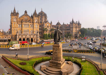 MUMBAI, INDIA - December 18, 2021 : Statue of Pherozeshah Mehta known as The Lion of Bombay with CST station,UNESCO World Heritage Site in Mumbaiのeditorial素材