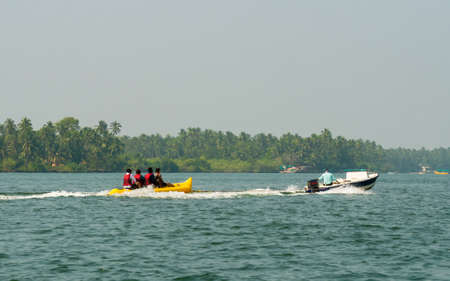 Malvan, INDIA - December 23, 2021 : Unidentified tourist enjoying a Banana ride at Tarkarli beach. The beach is famous for various water sports activities.のeditorial素材