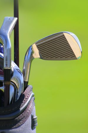 shallow depth of feald of golf clubs with green backgroundの写真素材