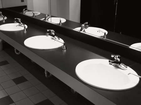 Bathroom wash basins and taps on black top