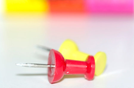 An abstract of red and yellow push pins