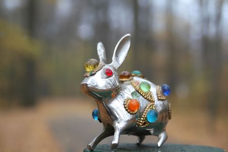 small metallic statue of rabbit with colorful crystals.の写真素材