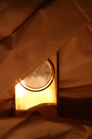 bright clock covered with the gold clothの写真素材