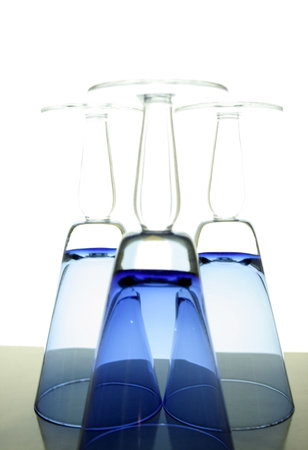 Beautiful blue colored glasses up side downの写真素材