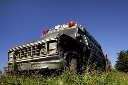 Old broken ambulance with blue sky backgroundの写真素材