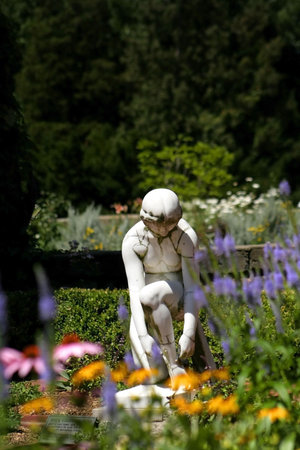 Statue In A Flower Gardenの写真素材