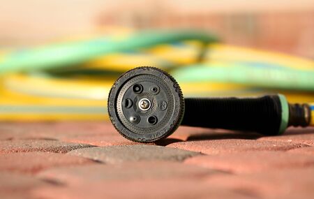 Close up shot of gardening hose on patioの写真素材