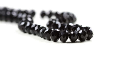 Chain with black beads on white backgroundの写真素材