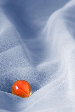 Orange marble against blue abstract backgroundの写真素材