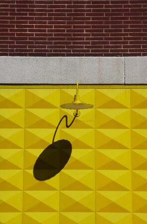 Lamp on a yellow wallの写真素材