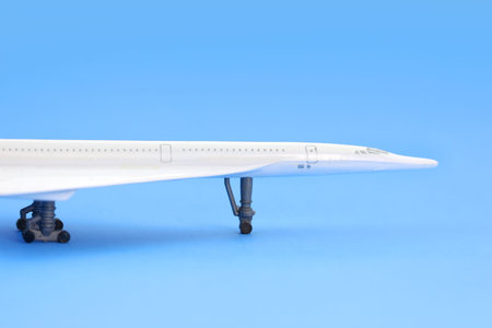 Toy airplane on plain blue background