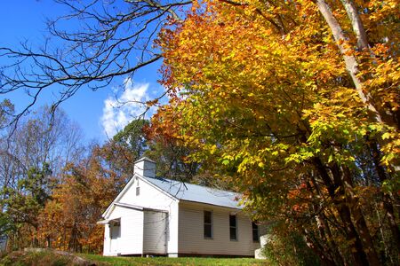 Historic small church in colorful autumn trees の写真素材