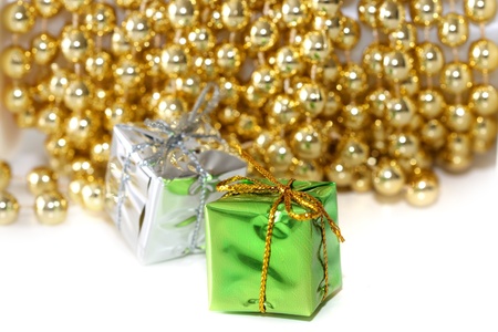Small christmas gifts against golden chain backgroundの写真素材