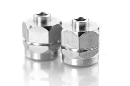 Two shiny metal valve nuts on white backgroundの写真素材