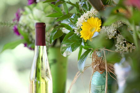 Wine bottle  and flower vase with nature backgroundの写真素材