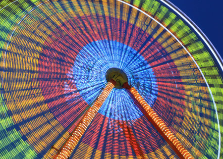 Illuminated Ferris wheel in motion