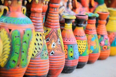Colorful handcrafted pots in a rowの写真素材