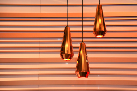 Three modern  lamps against striped wallの写真素材